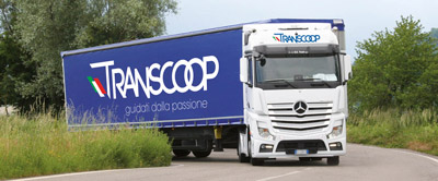 Camion Transcoop blu che svolta